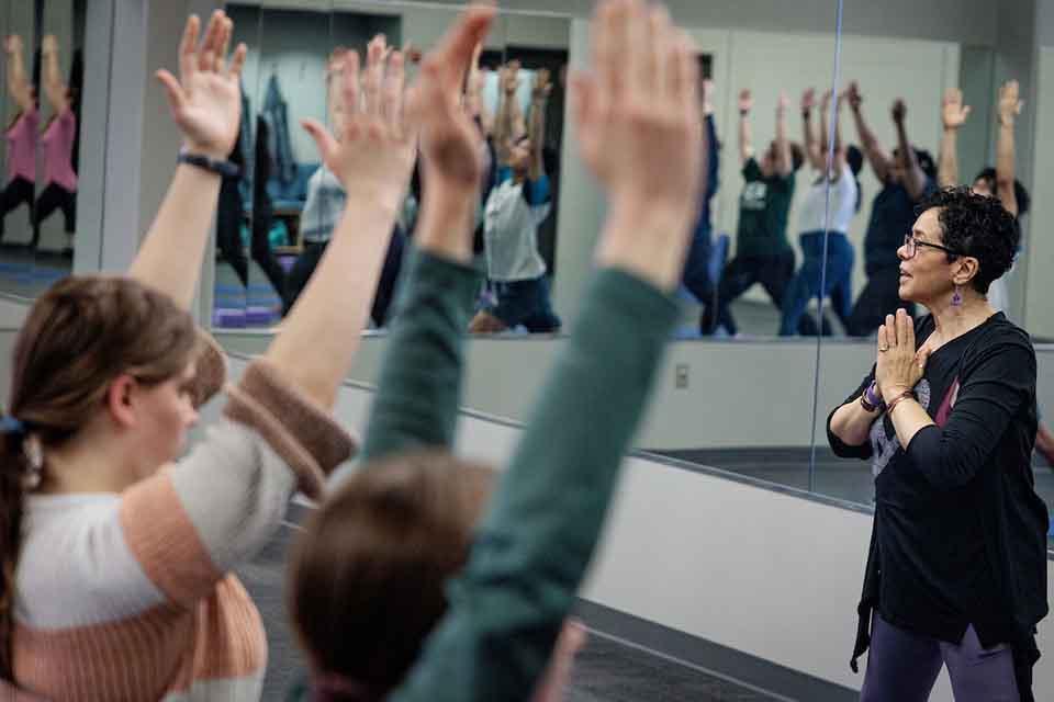 Students practice a yoga flow